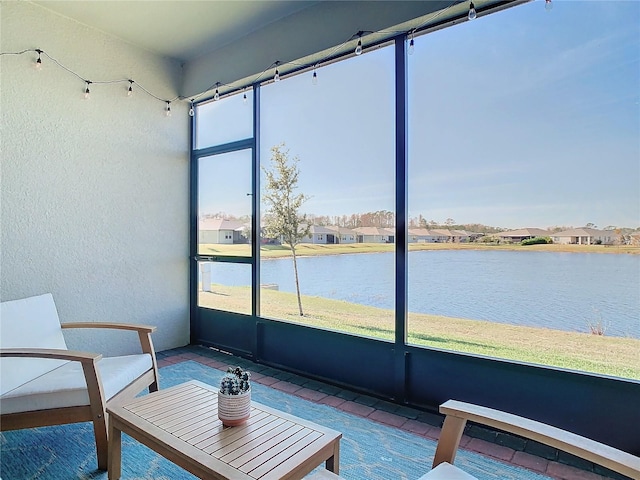 unfurnished sunroom with a water view