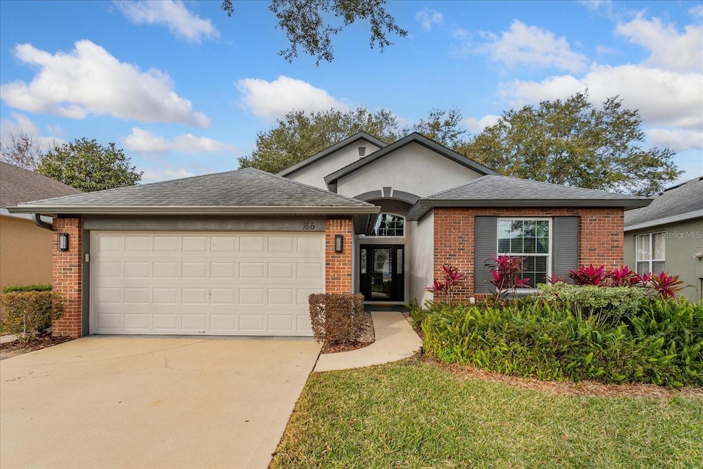 view of front facade with a front lawn and a garage