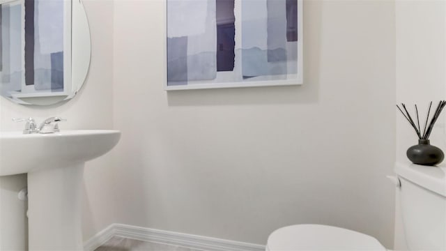 bathroom featuring sink and toilet