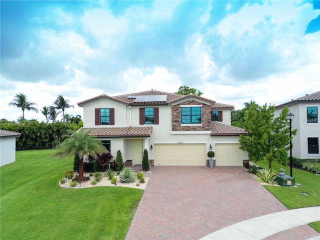 mediterranean / spanish-style home with a front lawn, a garage, and solar panels