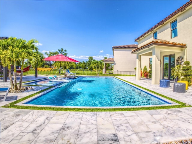 view of pool with pool water feature and a patio area