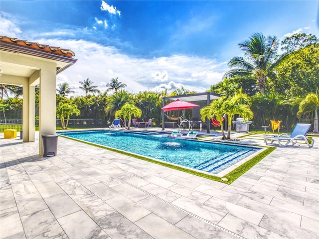 view of swimming pool with pool water feature and a patio