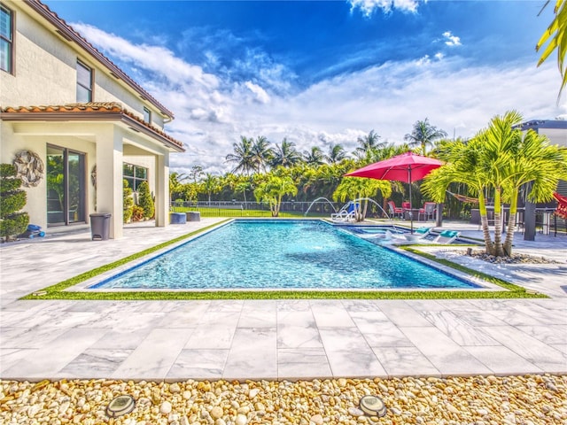 view of pool featuring pool water feature and a patio area