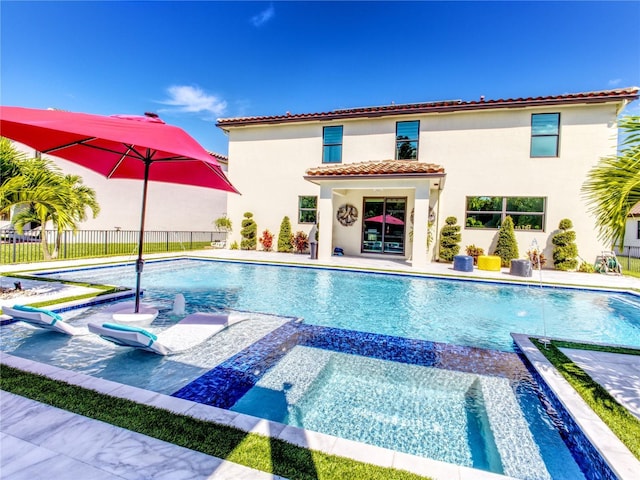 view of swimming pool with an in ground hot tub and a patio