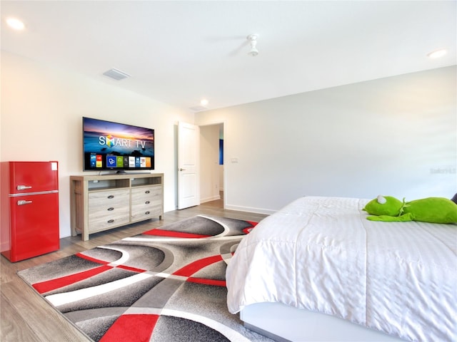 bedroom with hardwood / wood-style floors