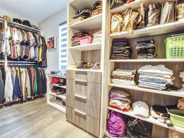 walk in closet featuring light hardwood / wood-style flooring