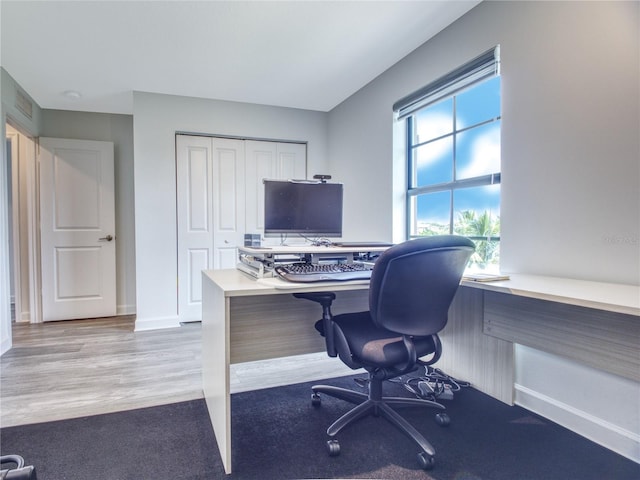 office space with light wood-type flooring