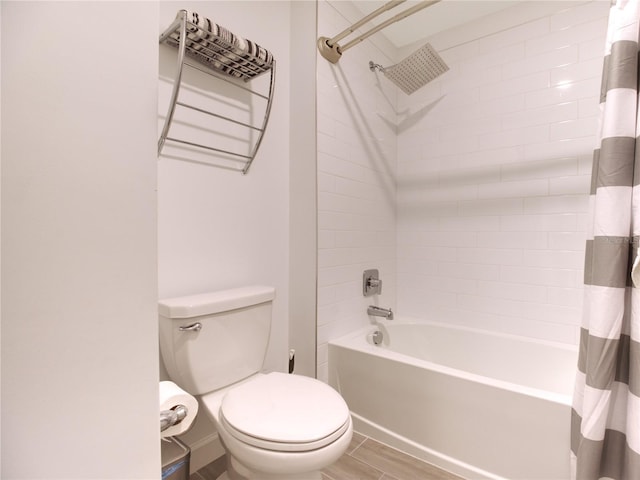 bathroom with shower / bath combo with shower curtain and toilet