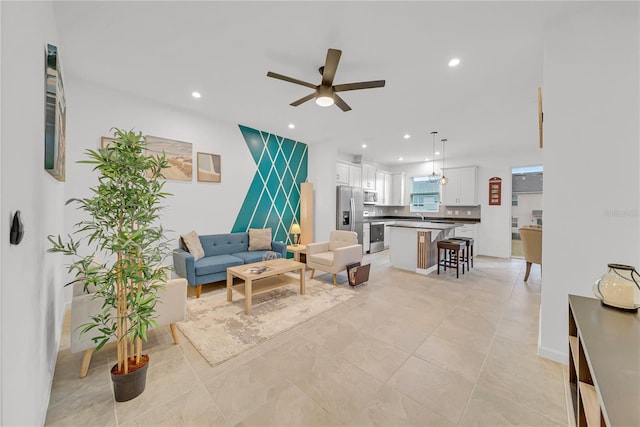 tiled living room featuring ceiling fan