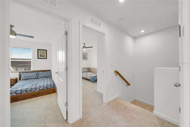 hallway with light colored carpet