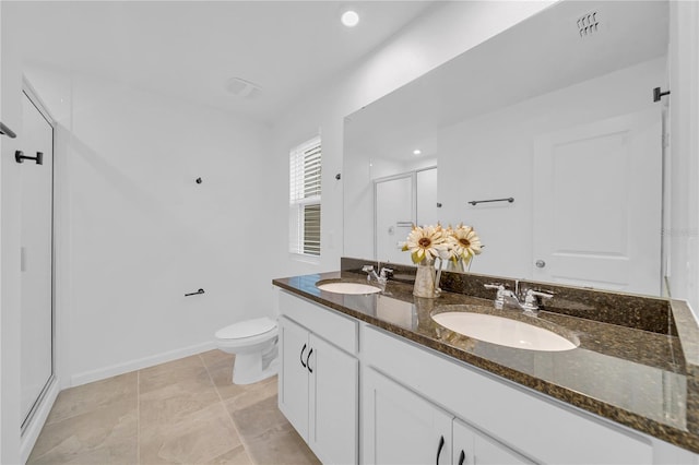 bathroom featuring toilet, walk in shower, and vanity