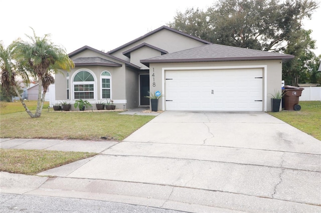 view of front of house featuring a front yard and a garage