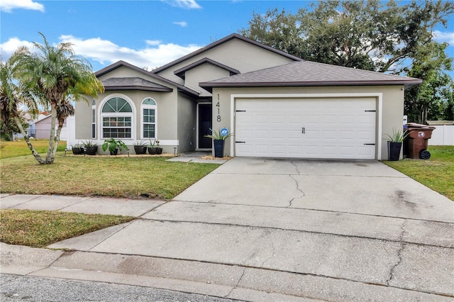 view of front facade with a garage and a front yard