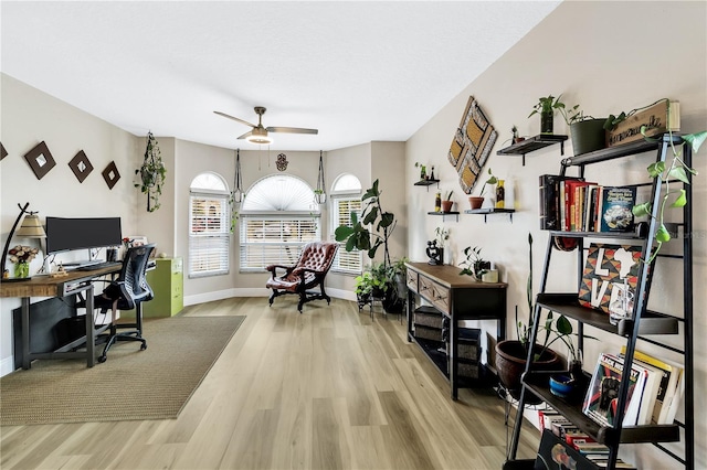 home office featuring light wood-type flooring and ceiling fan