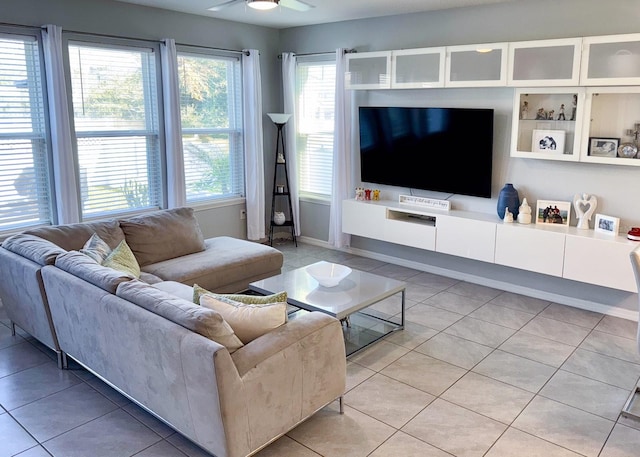 tiled living room with ceiling fan and plenty of natural light