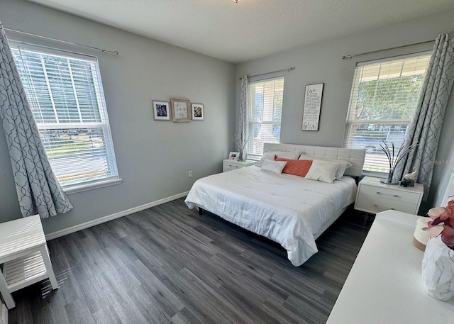 bedroom with dark wood-type flooring and a textured ceiling