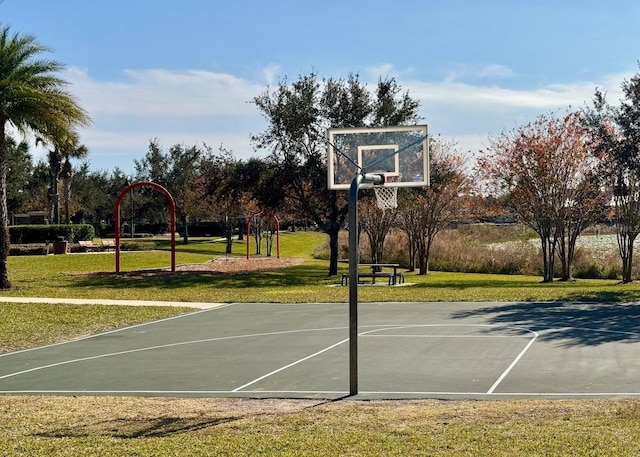 view of sport court with a lawn