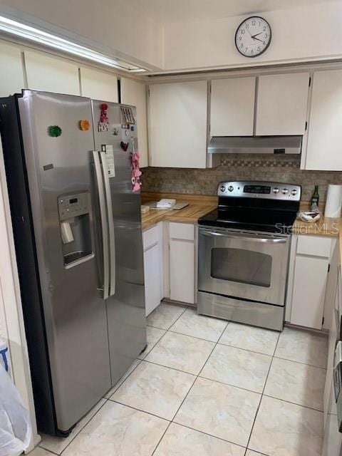 kitchen featuring tasteful backsplash, white cabinets, light tile patterned floors, and stainless steel appliances