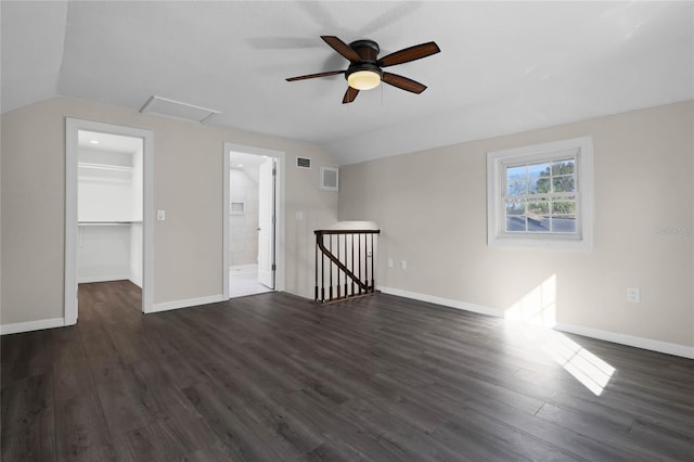 bonus room with dark wood-type flooring and vaulted ceiling