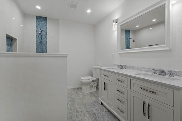 bathroom featuring vanity, walk in shower, and toilet