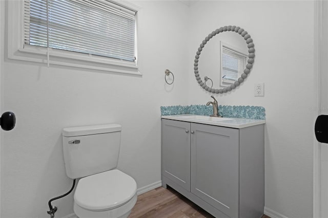 bathroom featuring vanity, hardwood / wood-style floors, and toilet