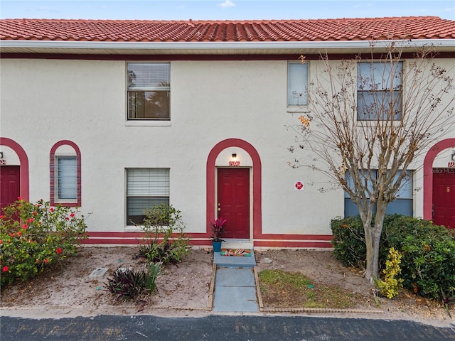 view of front of home featuring a tile roof and stucco siding