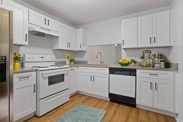 kitchen featuring white appliances, a sink, white cabinetry, and under cabinet range hood