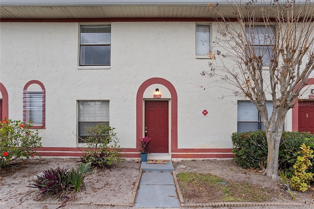 property entrance with stucco siding