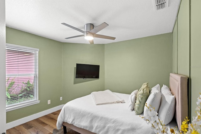 bedroom featuring ceiling fan and hardwood / wood-style flooring