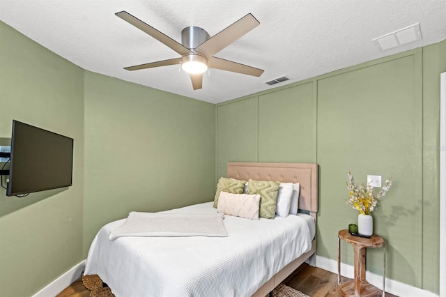 bedroom featuring ceiling fan and dark hardwood / wood-style flooring