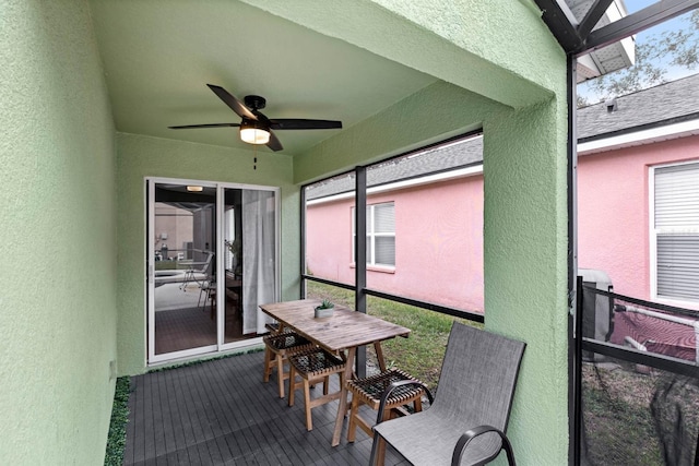 sunroom featuring ceiling fan and a wealth of natural light