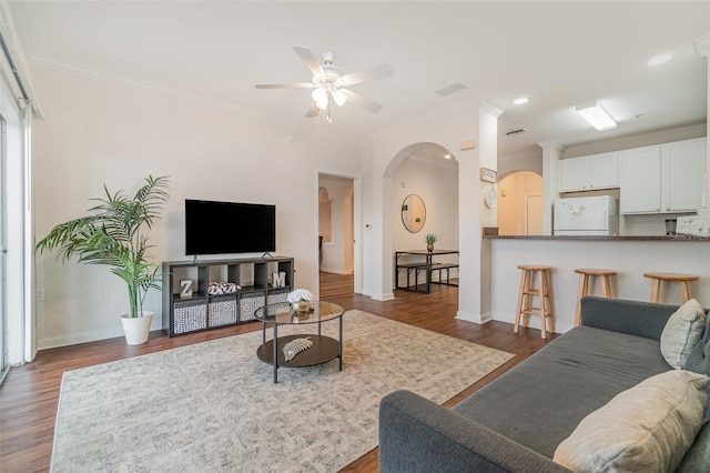 living room featuring crown molding, ceiling fan, and dark hardwood / wood-style flooring