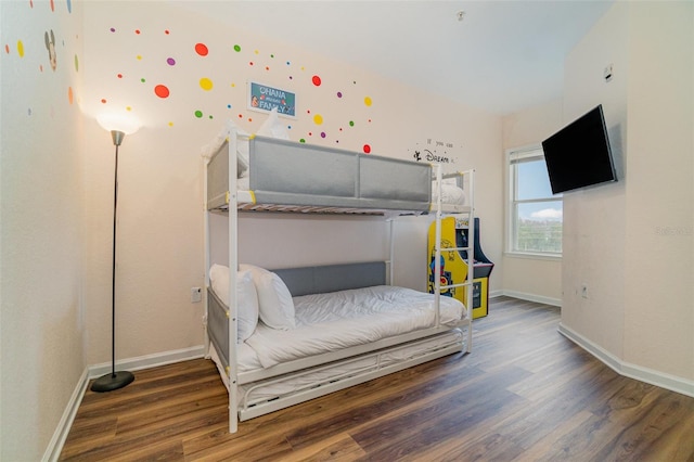 bedroom with dark hardwood / wood-style floors