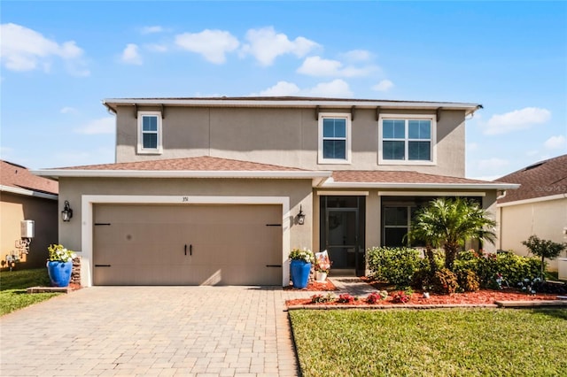 view of front of house with a front yard and a garage