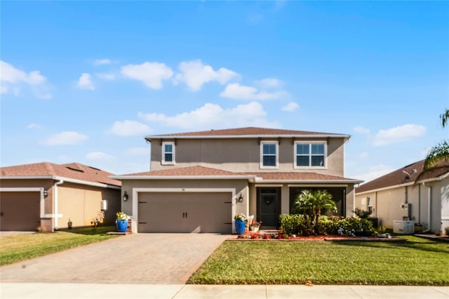 view of front of house featuring a garage and a front lawn