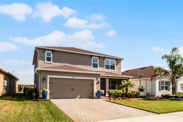 view of front property featuring a garage and a front yard