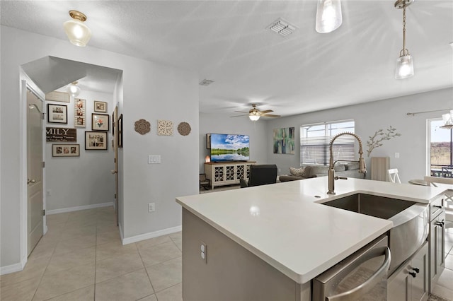 kitchen with decorative light fixtures, dishwasher, a healthy amount of sunlight, and an island with sink