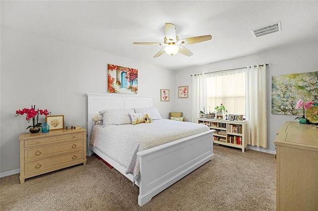 bedroom with ceiling fan and light carpet