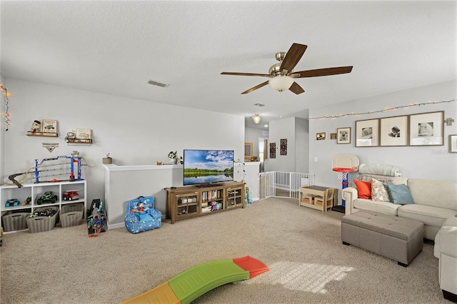 carpeted living room with a textured ceiling and ceiling fan