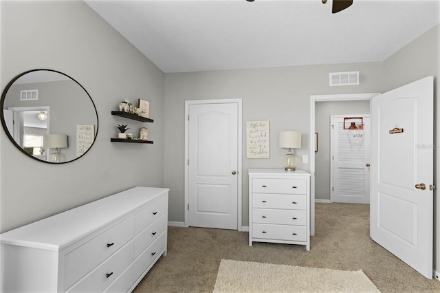 bedroom with ceiling fan, a textured ceiling, and light carpet