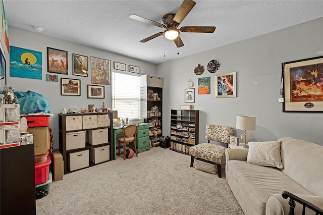 interior space featuring a textured ceiling, carpet flooring, and ceiling fan