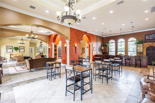 351 Lazio Cir, Debary, FL 32713 - dining area with crown molding, recessed lighting, light tile patterned floors, a tray ceiling, and arched walkways
