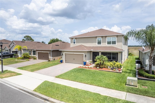 351 Lazio Cir, Debary, FL 32713 - traditional home featuring stucco siding, a garage, driveway, and a front yard