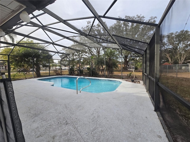 view of pool featuring glass enclosure and a patio