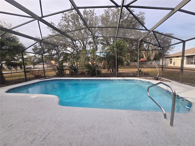 view of swimming pool with a lanai and a patio area