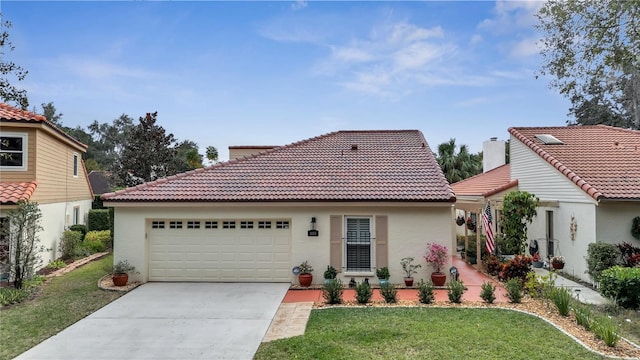 mediterranean / spanish-style house featuring a front yard and a garage