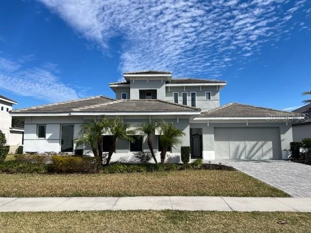 view of front of property with a garage and a front yard