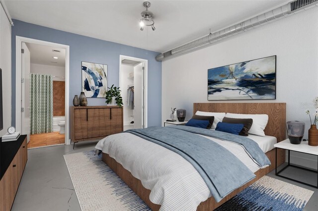 bedroom featuring ensuite bathroom and a spacious closet