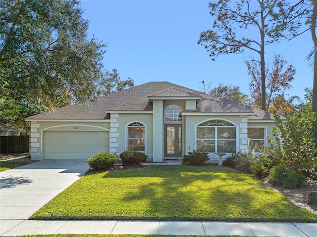 view of front of home featuring a garage and a front lawn