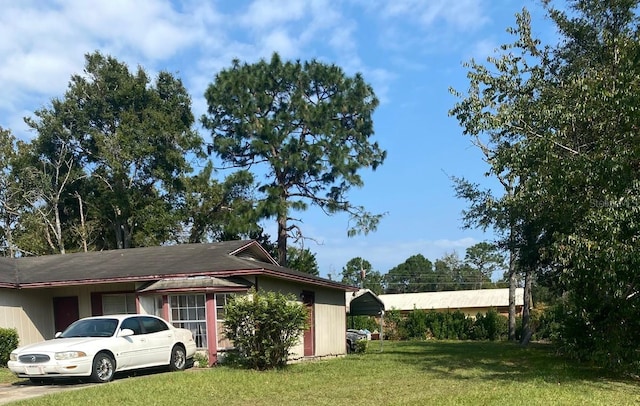 view of side of home with a lawn